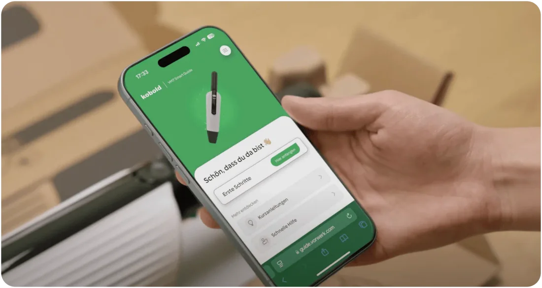 Customer following a Lulaa guide on a phone while setting up a Vorwerk device